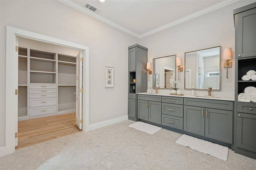 3129 Flowerdale Lane, Dallas, TX 75229 Dual vanity with integrated sinks, framed mirrors, and wall-mounted sconces