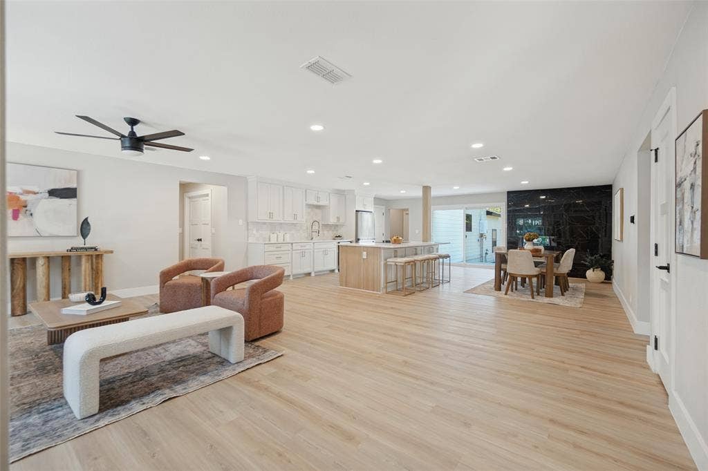 3129 Flowerdale Lane, Dallas, TX 75229 Open-concept living space featuring wood-finish flooring, recessed lighting, and a modern ceiling fan