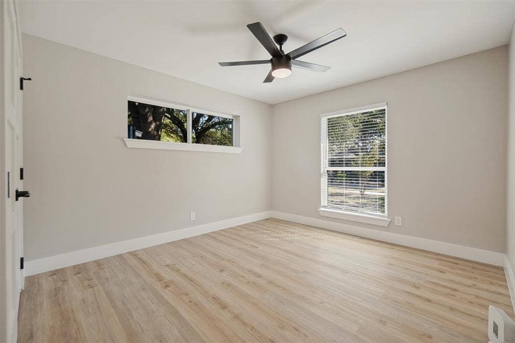 3129 Flowerdale Lane, Dallas, TX 75229 Light wood-finish flooring, overhead ceiling fan with lighting, and multiple windows