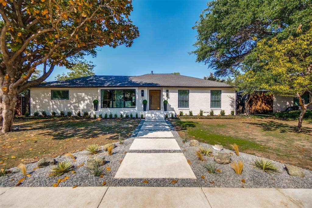 3129 Flowerdale Lane, Dallas, TX 75229 White brick exterior with a dark roof and large dark-framed windows