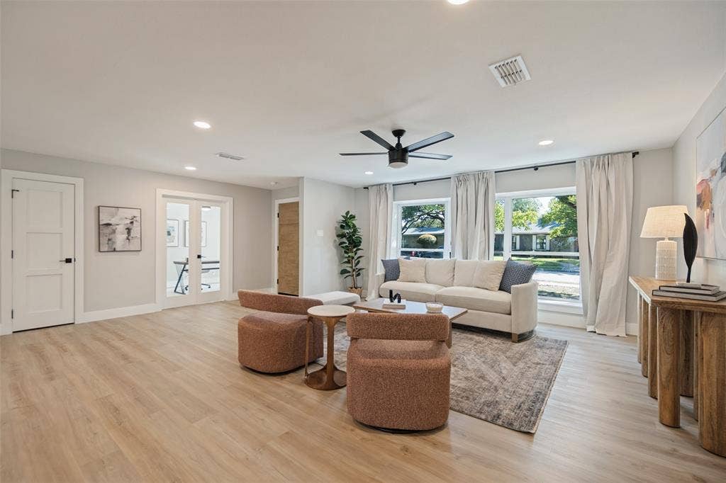 3129 Flowerdale Lane, Dallas, TX 75229 Recessed lighting, wood-finish flooring, ceiling fan, and large windows with privacy drapes