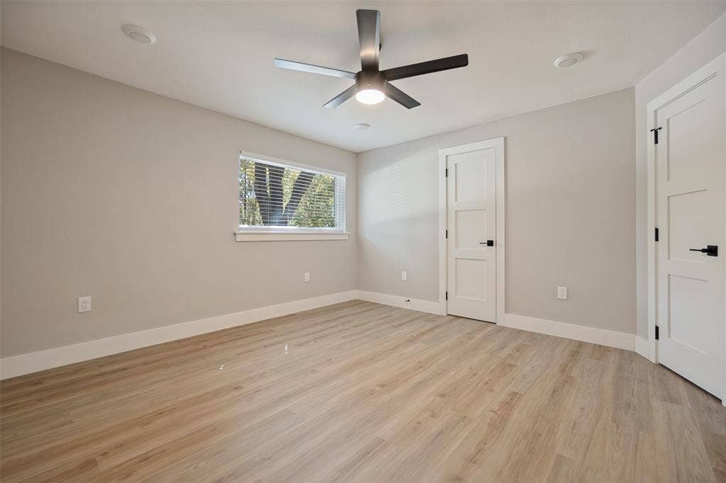 3129 Flowerdale Lane, Dallas, TX 75229 Light wood-finish flooring, neutral wall paint, and white trim throughout