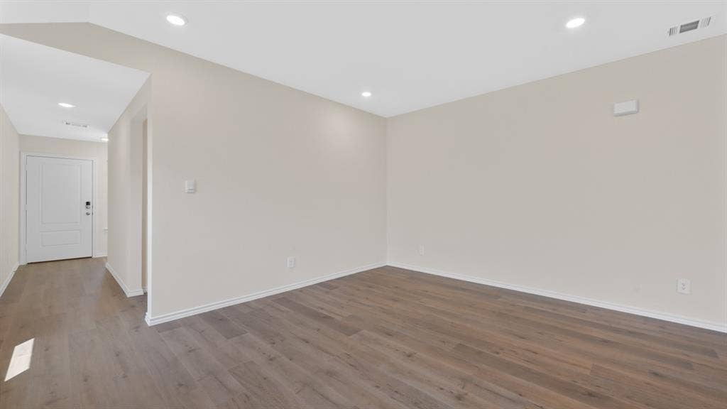 5431 Cormorant Grove, Crandall, TX 75114 Spacious room featuring wood-finish flooring, recessed lighting, neutral wall tones, and white baseboards