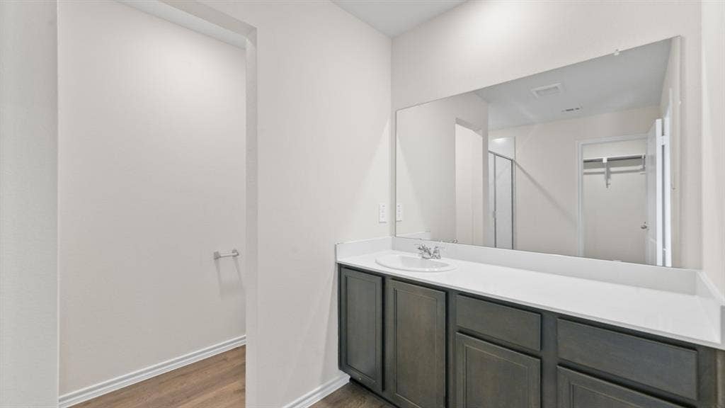 5431 Cormorant Grove, Crandall, TX 75114 Bathroom vanity featuring a single basin, a white countertop, and dark wood-finish cabinetry