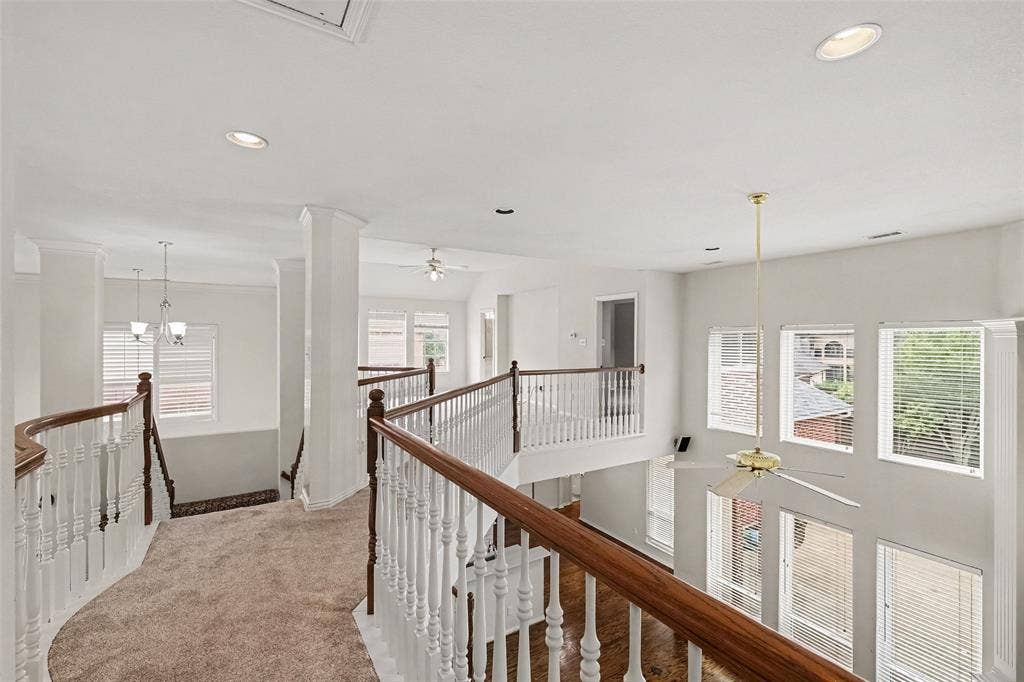 7813 San Isabel Drive, Plano, TX 75025 Open concept upper level featuring carpeted flooring, wood-finish handrails, white balusters, recessed lighting, and multiple windows