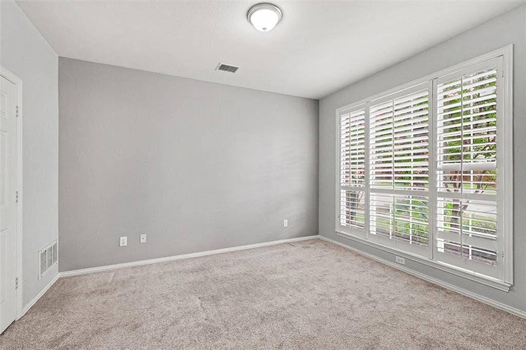 7813 San Isabel Drive, Plano, TX 75025 Neutral wall color, carpet flooring, window with white plantation shutters, white trim, and a ceiling-mounted light fixture