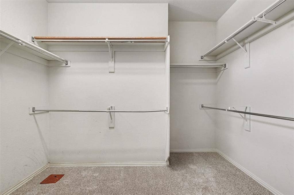 7813 San Isabel Drive, Plano, TX 75025 Carpeted walk-in closet with multiple white wire shelves, wood-finish shelving, and metal hanging rods