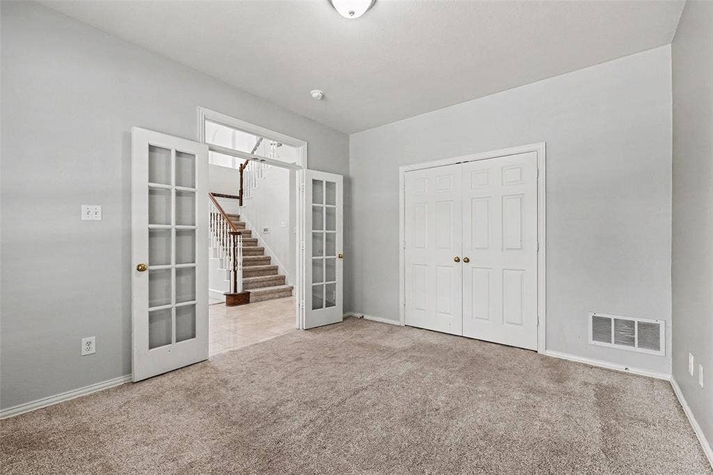 7813 San Isabel Drive, Plano, TX 75025 Carpeted room featuring French doors, a built-in closet, and a ceiling light fixture