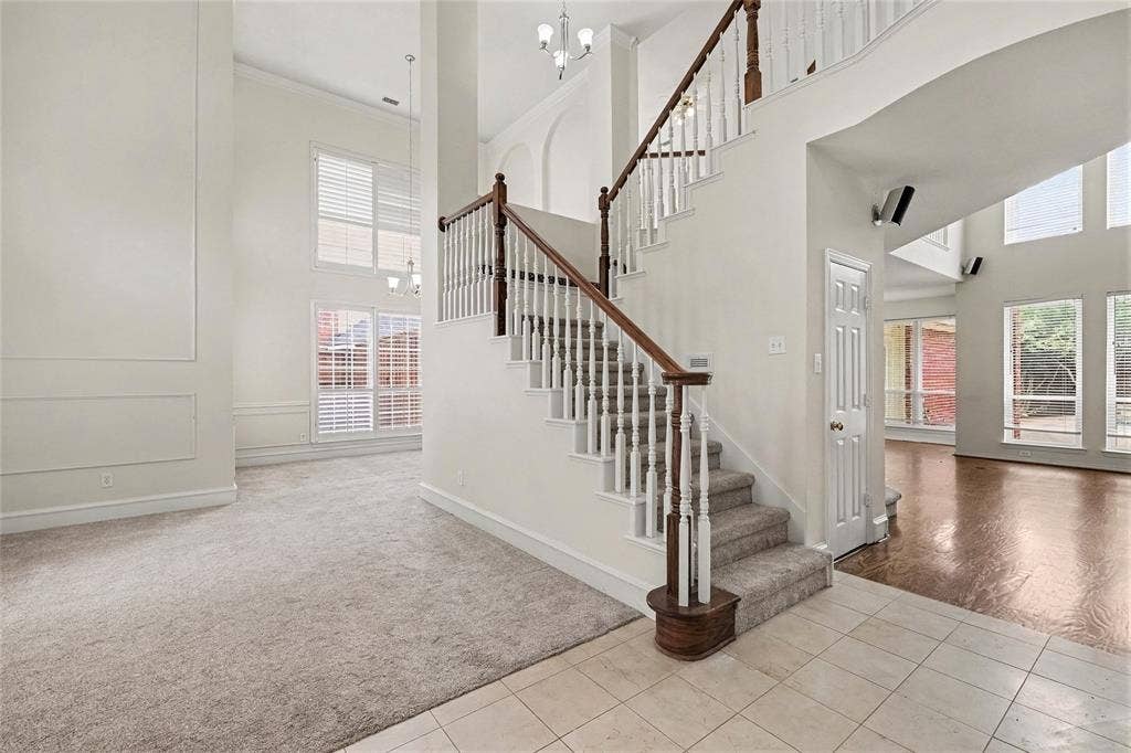 7813 San Isabel Drive, Plano, TX 75025 Two-story foyer with a grand staircase and decorative balusters
