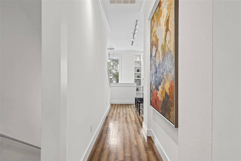 4312 Mckinney Avenue, #4, Dallas, TX 75205 Wood-finish flooring with white baseboards, crown molding, built-in shelving, and recessed lighting