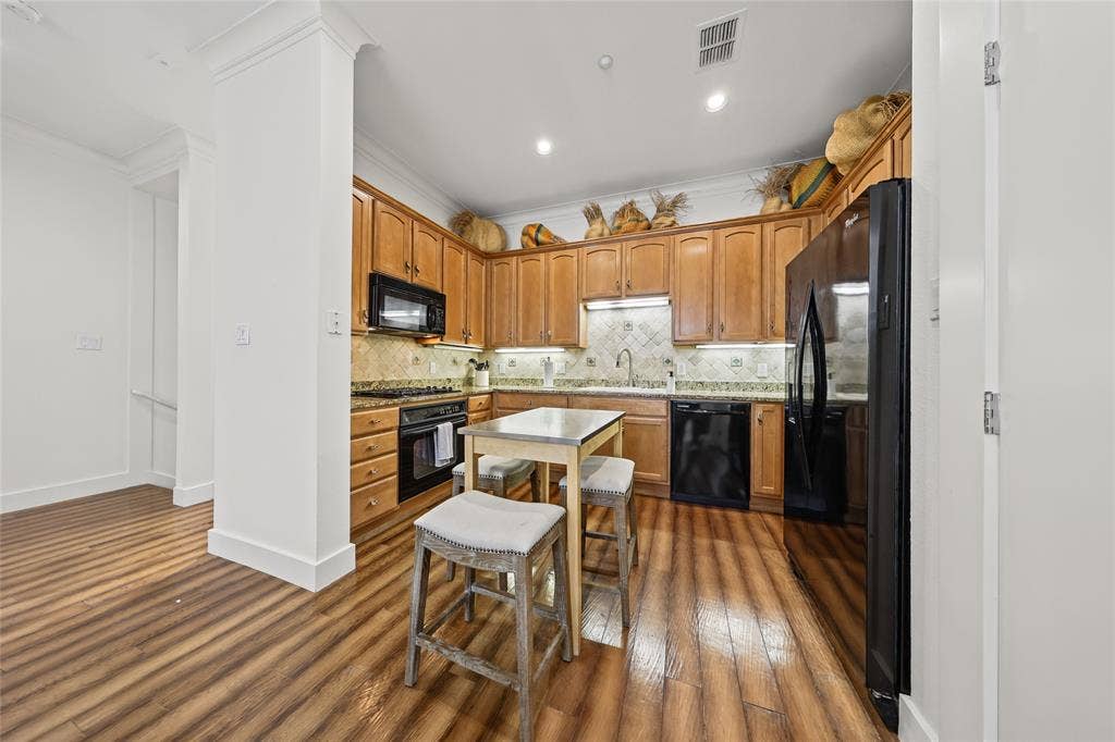 4312 Mckinney Avenue, #4, Dallas, TX 75205 Kitchen featuring wood-finish flooring, recessed lighting, wood cabinetry, stone countertops, and a tile backsplash