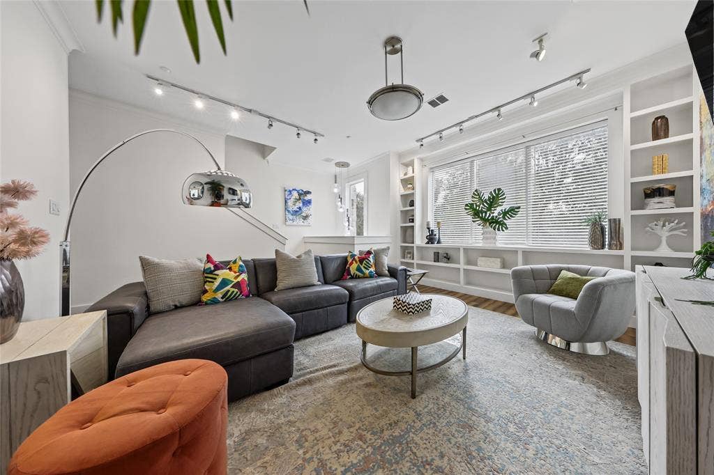 4312 Mckinney Avenue, #4, Dallas, TX 75205 Bright living space with built-in shelving, wood-finish flooring, and recessed ceiling lighting