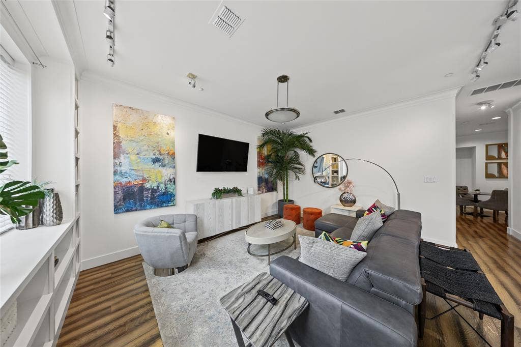 4312 Mckinney Avenue, #4, Dallas, TX 75205 Hardwood-finish flooring, built-in shelving, white walls, recessed lighting, and a modern ceiling fixture