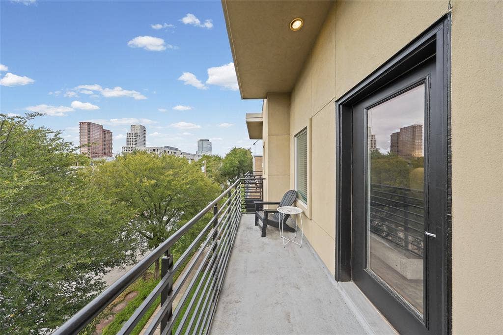4312 Mckinney Avenue, #4, Dallas, TX 75205 Balcony with concrete flooring and metal railings, featuring a full-light exterior door and recessed lighting