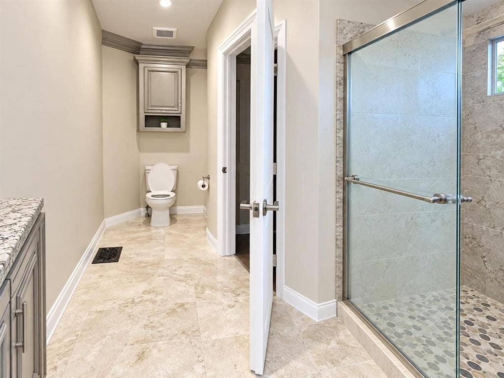 1410 Nadine Lane, Grand Prairie, TX 75052 Glass-enclosed shower with pebble-style flooring, tiled walls, and a window