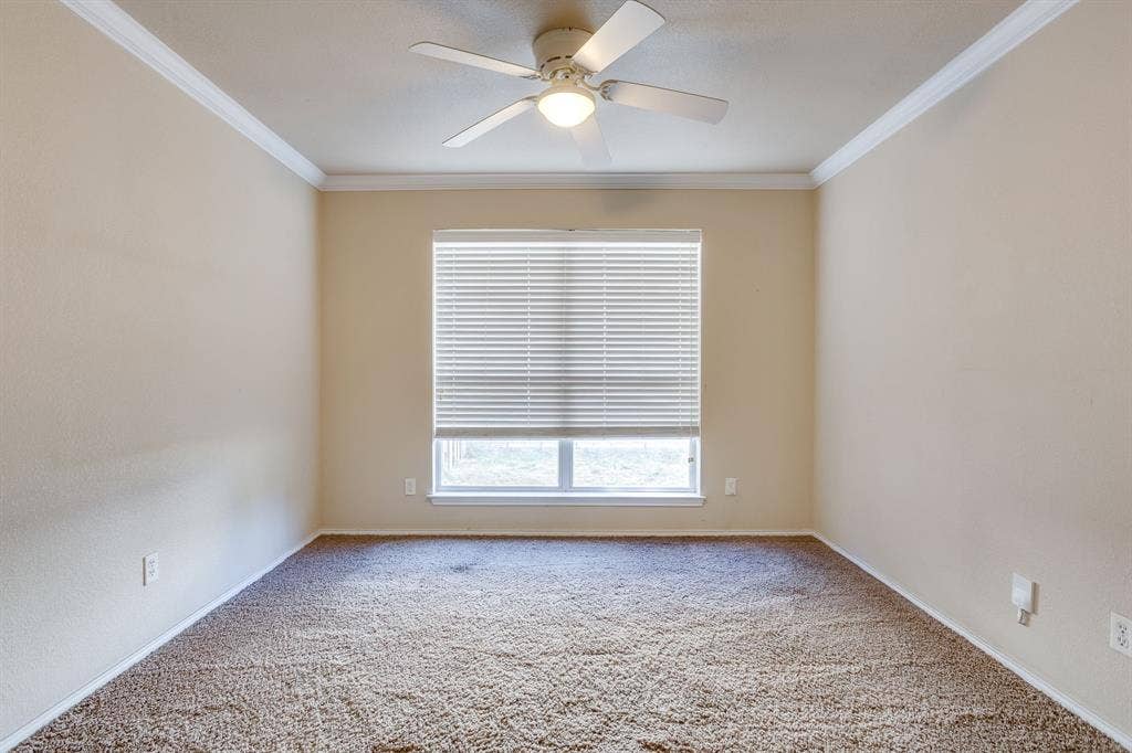Recessed window with blinds, ceiling fan with integrated lighting, crown molding, and neutral wall tones