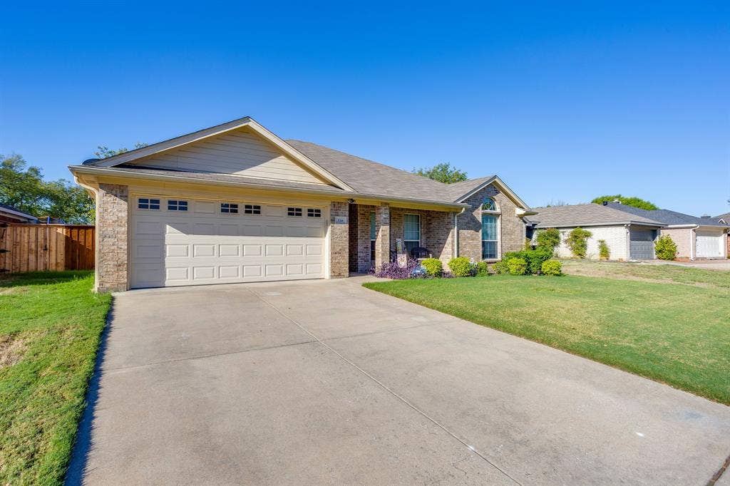 Brick exterior with a gabled roof and attached garage