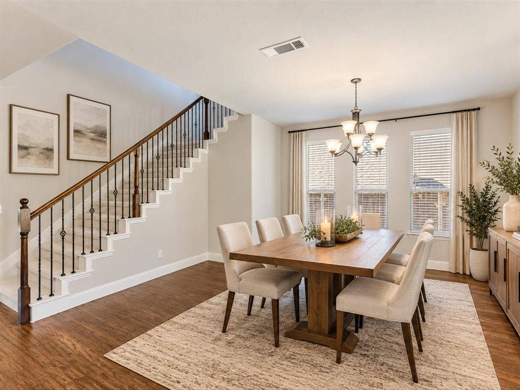 1020 Fallon Drive, McKinney, TX 75071 Hardwood-style flooring throughout, staircase with wood handrail and wrought iron spindles, recessed lighting, and chandelier