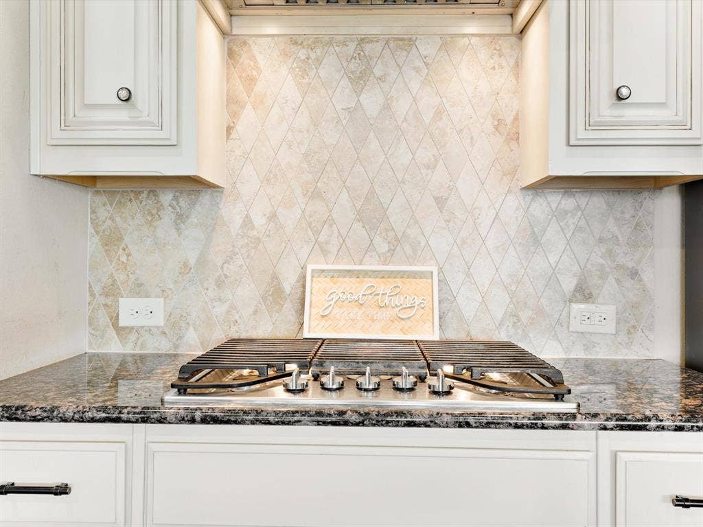 1020 Fallon Drive, McKinney, TX 75071 Built-in gas cooktop with polished metal accents, set within a speckled countertop