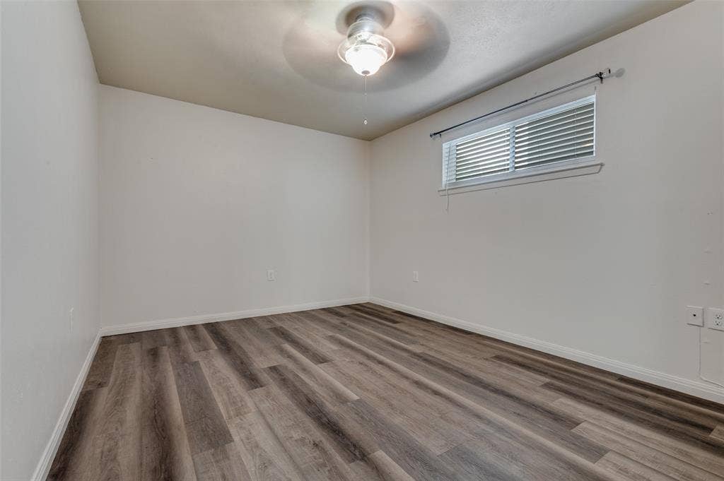 428 N Dallas Avenue, #3, Lancaster, TX 75146 Wood-finish flooring, white walls, window with horizontal blinds, overhead ceiling light fixture, and white trim