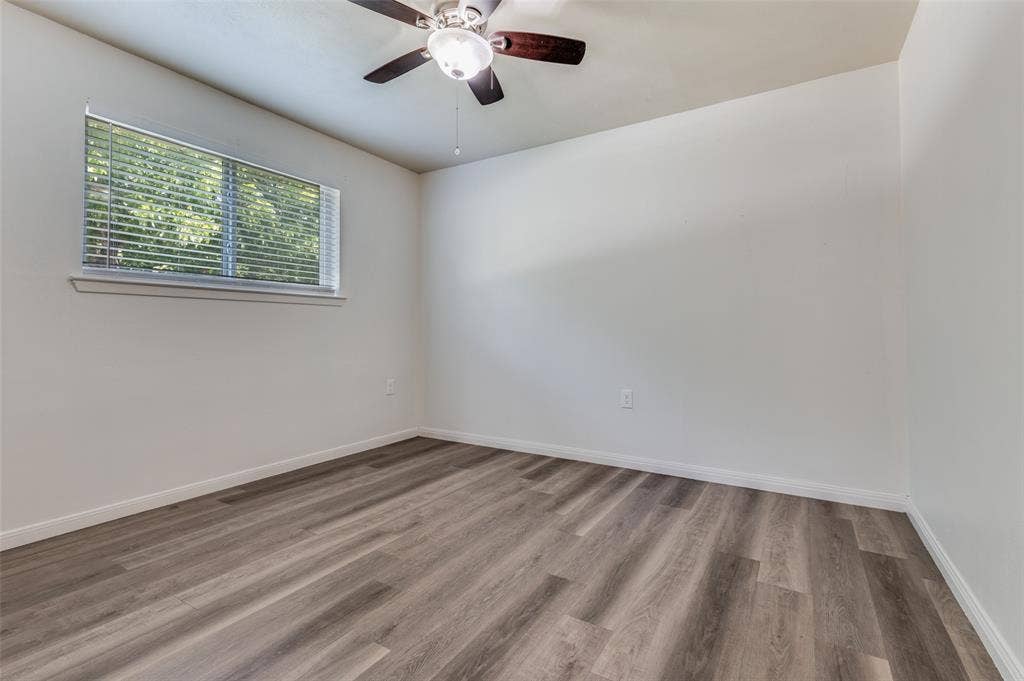 428 N Dallas Avenue, #3, Lancaster, TX 75146 Wood-finish flooring, white walls, window with blinds, and a ceiling fan with integrated lighting