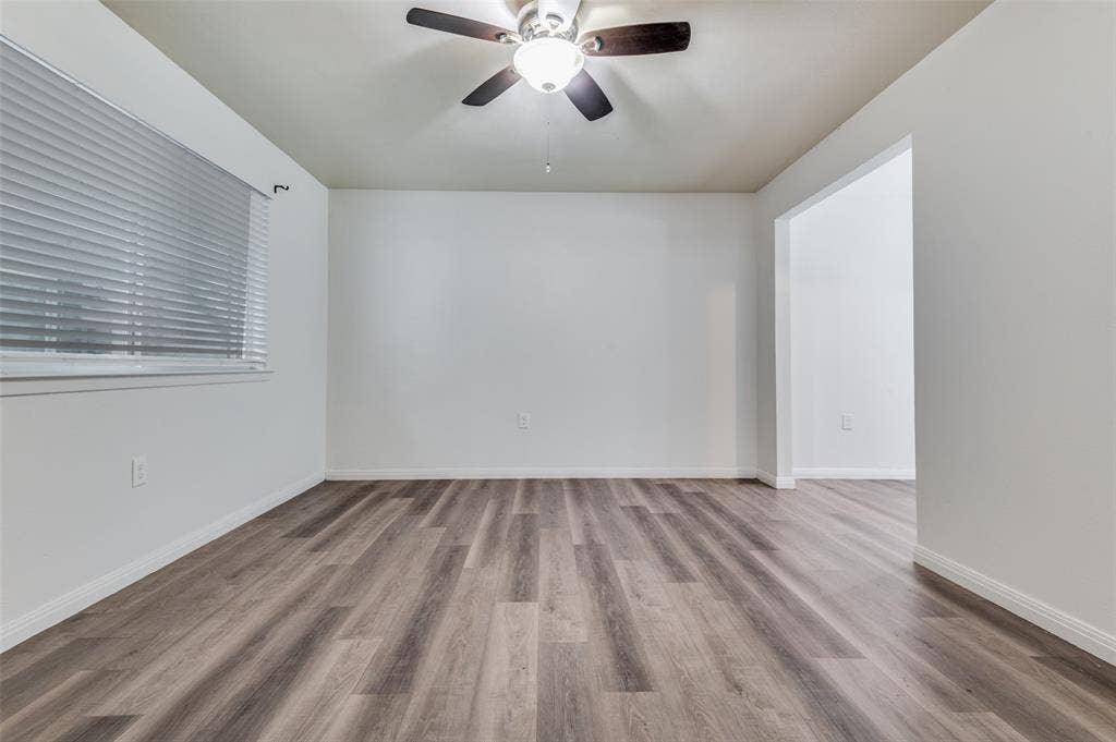 428 N Dallas Avenue, #3, Lancaster, TX 75146 Wood-finish flooring, white walls, and a ceiling fan with integrated lighting
