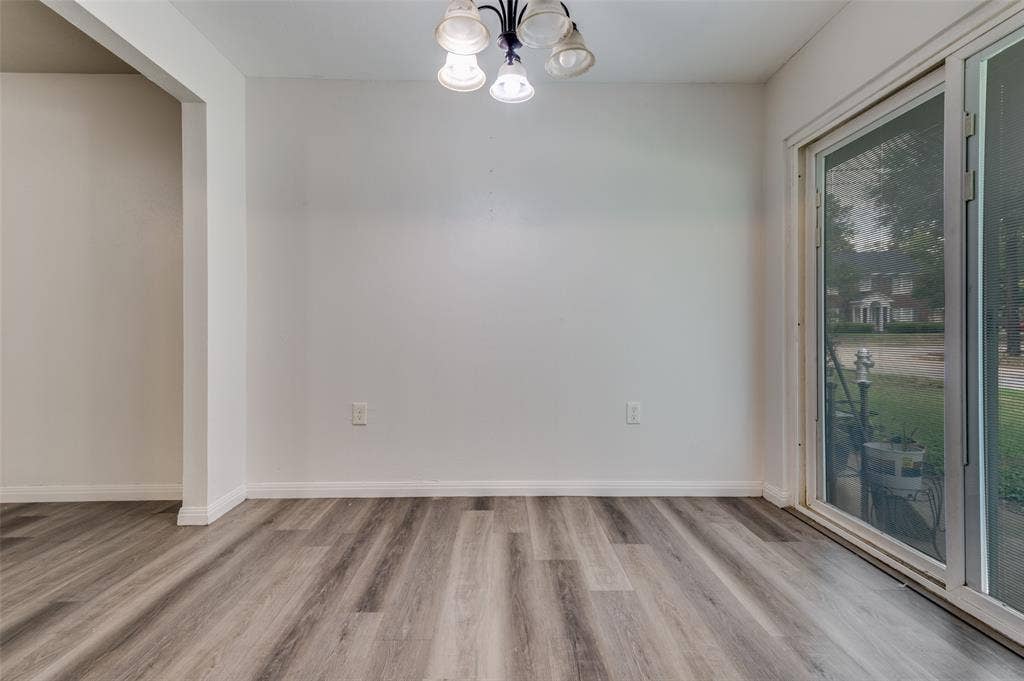 428 N Dallas Avenue, #3, Lancaster, TX 75146 Wood-finish flooring, white walls, overhead ceiling light fixture, and sliding glass door
