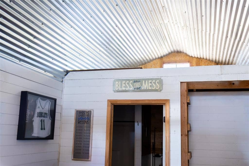 Tiny House has a loft, large bedroom, kitchen, living areas.
