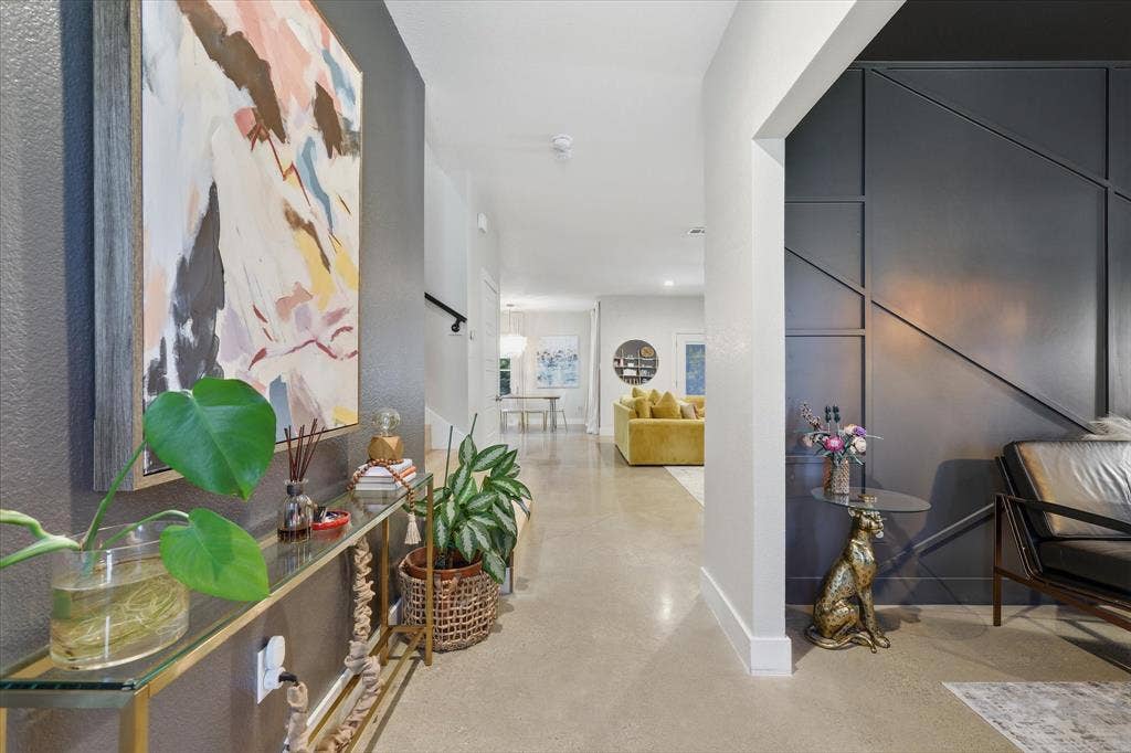 709 Woodbine Avenue, Dallas, TX 75203 Smooth flooring, contemporary wall paneling, recessed lighting, and a modern stair railing