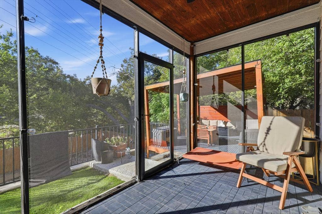 709 Woodbine Avenue, Dallas, TX 75203 Screened-in porch featuring a wood-panel ceiling, patterned flooring, and direct access to an outdoor deck