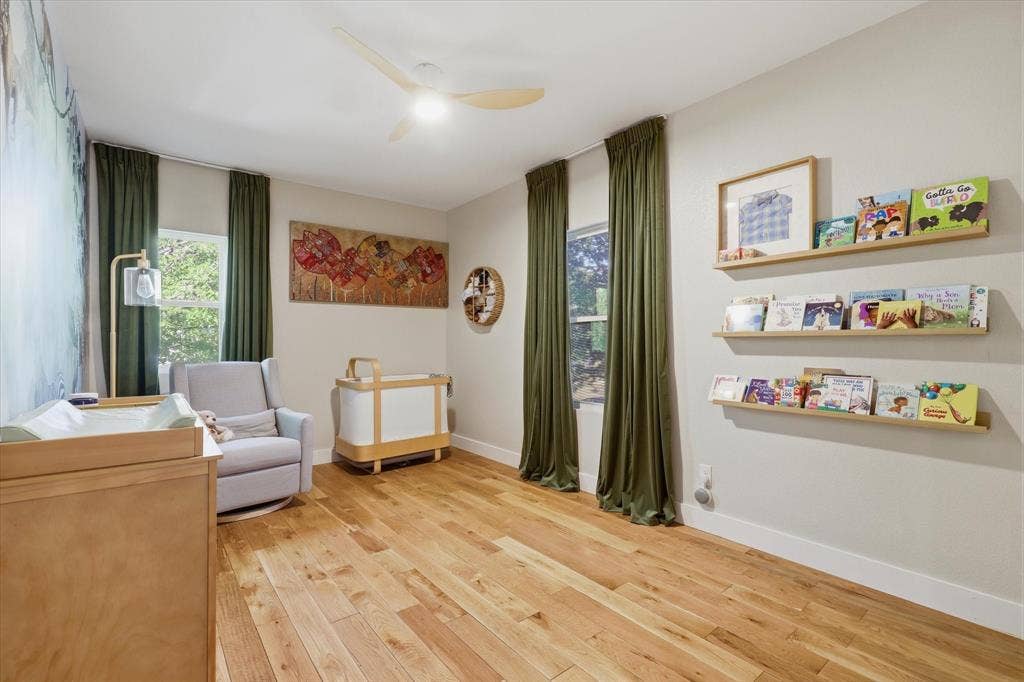 709 Woodbine Avenue, Dallas, TX 75203 Recessed lighting and a ceiling fan illuminate the light wood flooring