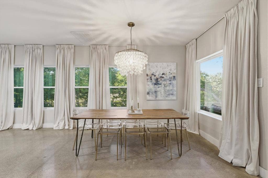 709 Woodbine Avenue, Dallas, TX 75203 Polished concrete flooring, multiple tall windows, modern chandelier, and light-toned wall paint