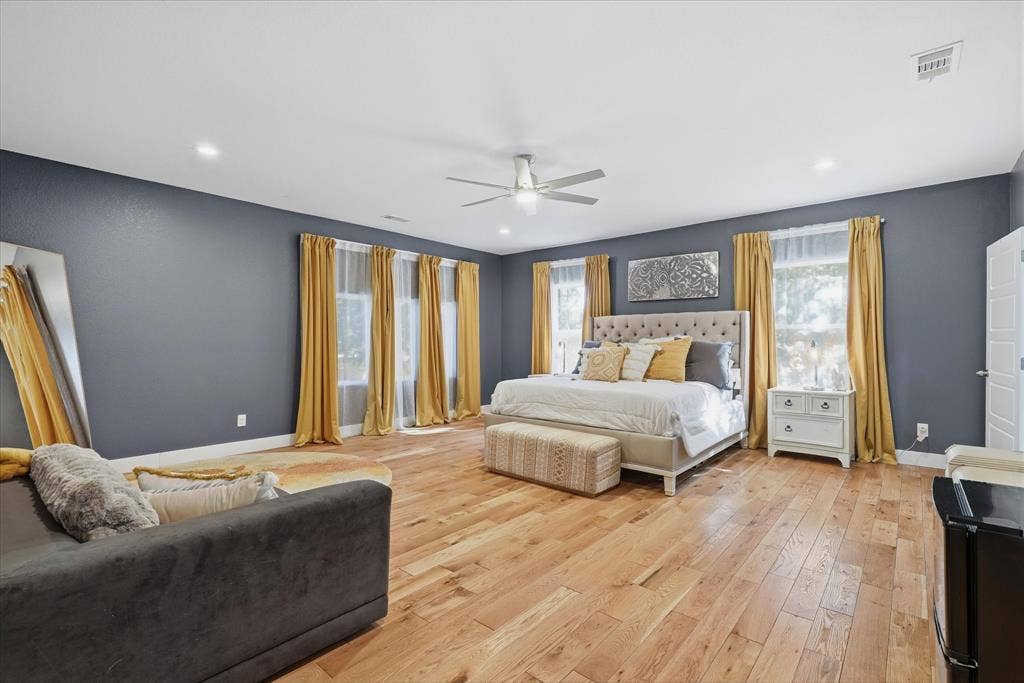 709 Woodbine Avenue, Dallas, TX 75203 Recessed lighting, wood-finish flooring, ceiling fan, multiple windows with natural light, and a white paneled door