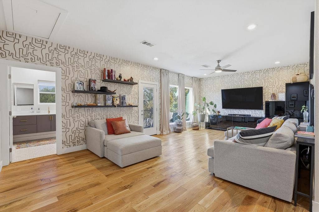 709 Woodbine Avenue, Dallas, TX 75203 Open concept room featuring wood-finish flooring, patterned accent walls, recessed lighting, and a ceiling fan