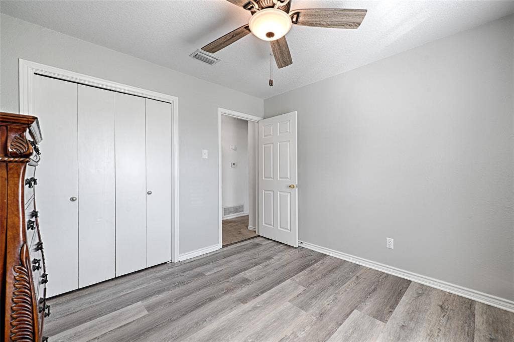 2909 Lee Park Drive, Irving, TX 75062 Wood-finish flooring, ceiling fan with integrated light fixture, and white six-panel interior door