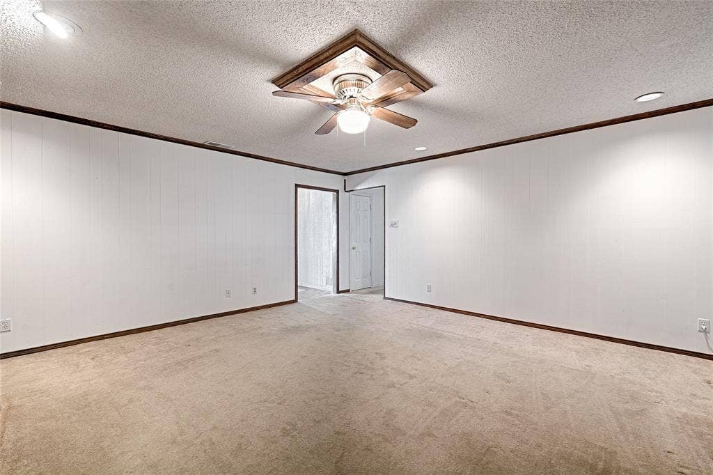 2909 Lee Park Drive, Irving, TX 75062 Interior space featuring wall-to-wall carpeting, recessed ceiling lighting, a wood-trimmed ceiling fan, and crown molding