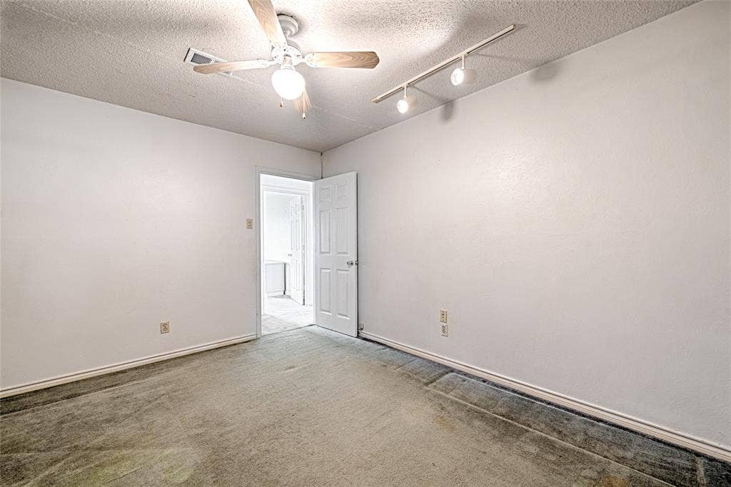 2909 Lee Park Drive, Irving, TX 75062 Interior space featuring neutral wall tones, carpeted flooring, a ceiling fan with integrated lighting, and adjustable multi-light track lighting