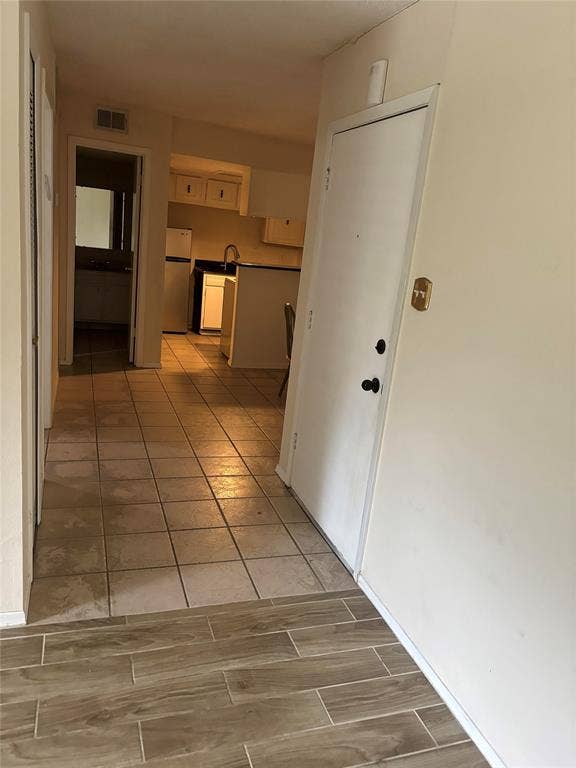 Hall with light tile floors