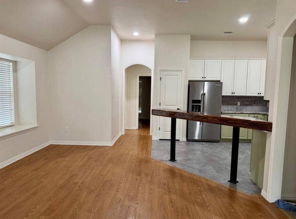 1001 Roberts Bend, Granbury, TX 76048 Wood-finish flooring, recessed lighting, and an arched doorway