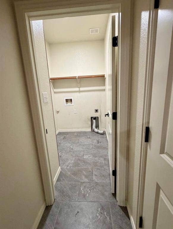 1001 Roberts Bend, Granbury, TX 76048 Dedicated utility space featuring durable tile flooring, wood shelving, and essential appliance hookups