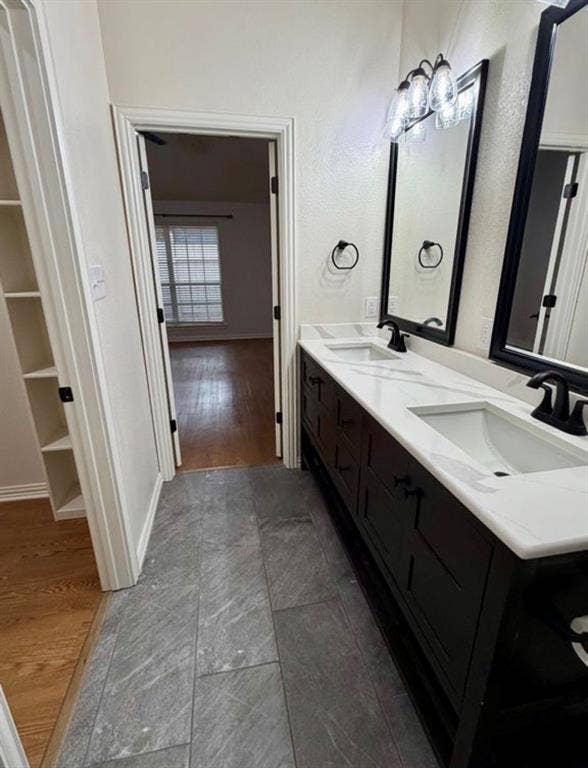 1001 Roberts Bend, Granbury, TX 76048 Dual vanity with white countertops, undermount sinks, and matte black fixtures