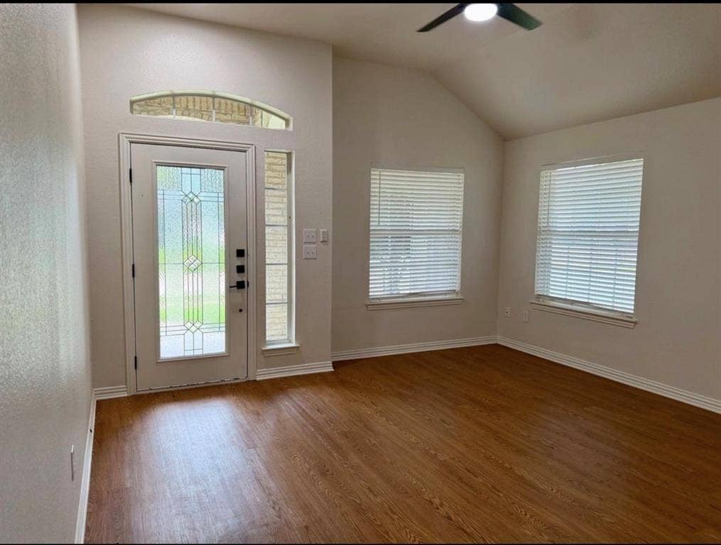 1001 Roberts Bend, Granbury, TX 76048 Bright foyer with elegant glass-paneled entry door featuring decorative beveled detailing, transom window above, and sidelite