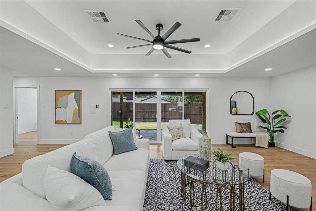 4004 Cedar Bayou Drive, Dallas, TX 75244 Tray ceiling with recessed lighting and a ceiling fan, wood-finish flooring, and large sliding glass doors