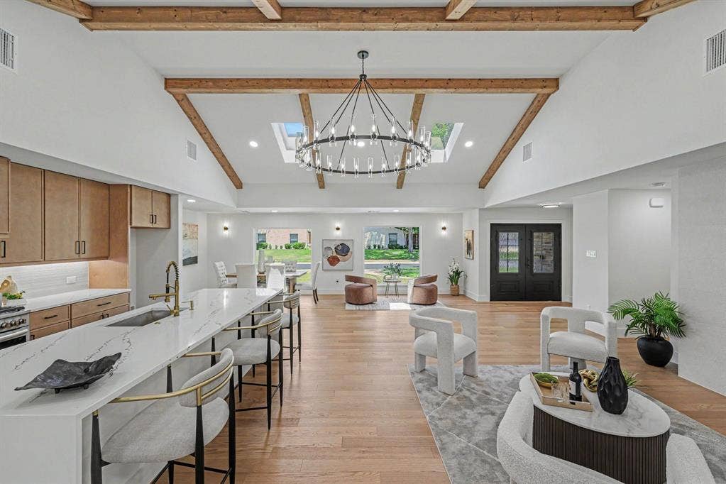 4004 Cedar Bayou Drive, Dallas, TX 75244 Vaulted ceiling with exposed wood beams, large central skylight, modern chandelier, and wood-finish flooring