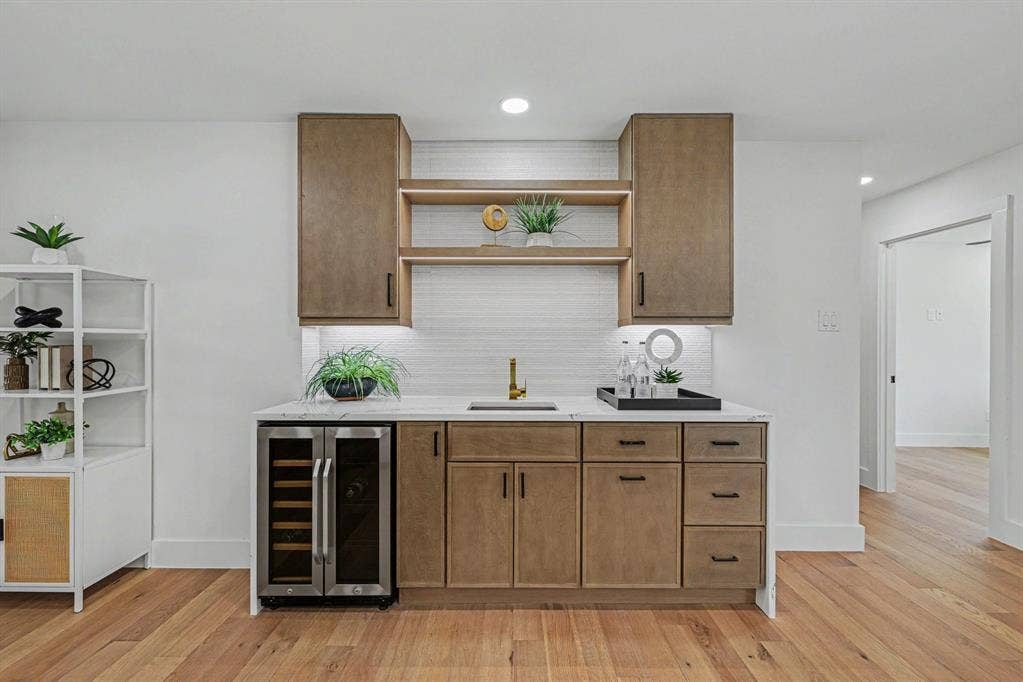 4004 Cedar Bayou Drive, Dallas, TX 75244 Built-in wet bar with wood-finish cabinetry, under-cabinet lighting, and a beverage refrigerator