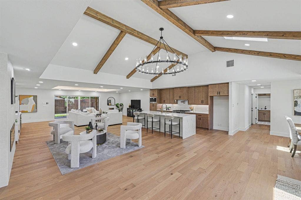 4004 Cedar Bayou Drive, Dallas, TX 75244 Vaulted ceilings with exposed beams, recessed lighting, wood-finish flooring, a kitchen island with seating, and sliding glass doors