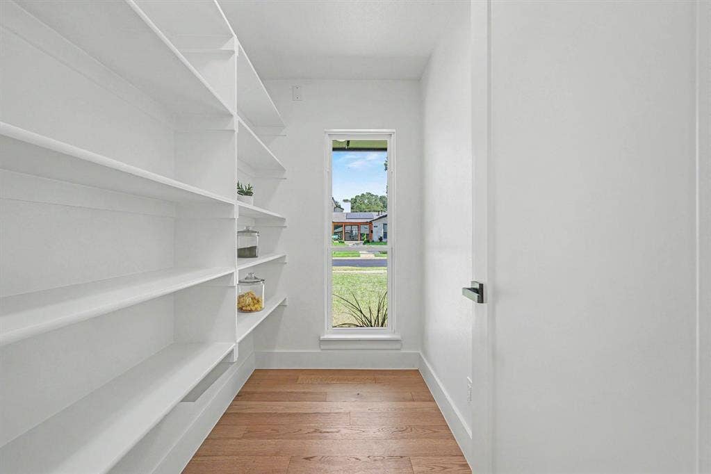 4004 Cedar Bayou Drive, Dallas, TX 75244 Built-in shelving for ample storage, wood-finish flooring, and a vertical window