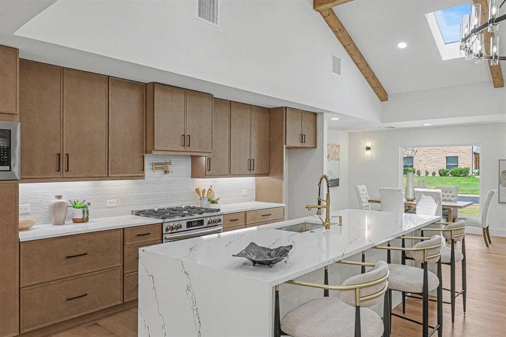 4004 Cedar Bayou Drive, Dallas, TX 75244 Vaulted ceiling with exposed wood beams, skylight, and recessed lighting
