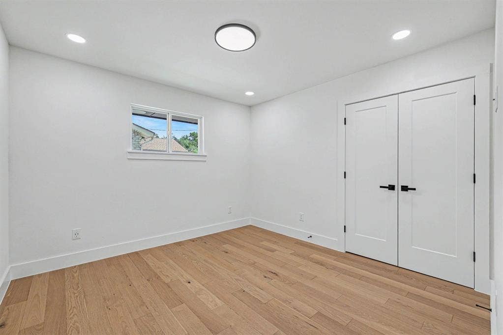 4004 Cedar Bayou Drive, Dallas, TX 75244 Recessed lighting, central ceiling light fixture, wood-finish flooring, white walls, and white double doors with matte black hardware