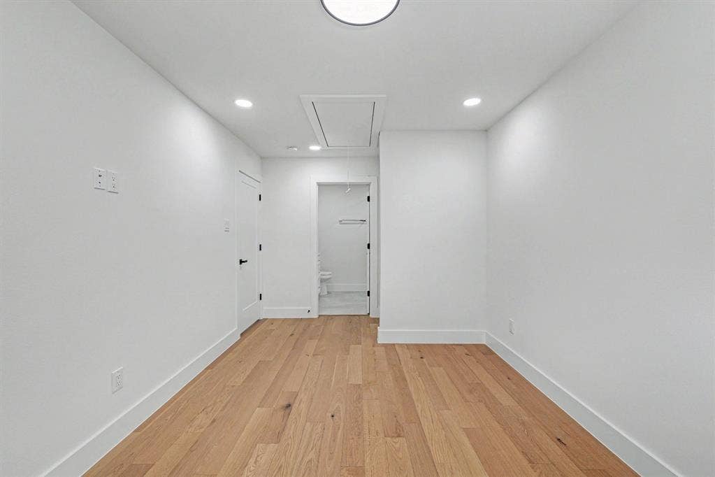 4004 Cedar Bayou Drive, Dallas, TX 75244 Recessed lighting, wood-finish flooring, white walls, and a white ceiling with a flush-mount light fixture